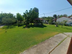 a large yard with a gazebo in the grass at Kanela House in Nea Kalikratia