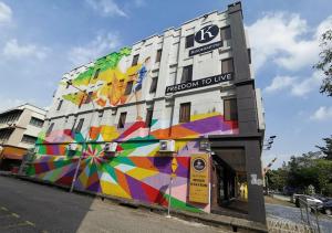 a building with a colorful mural on the side of it at Kino Hotel in Shah Alam