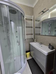 a bathroom with a glass shower and a sink at Tito Pomponio in Frosinone +7 photos