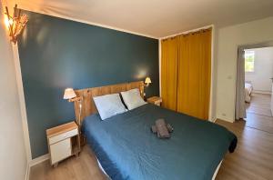 a bedroom with a bed with a backpack on it at Escapade aux portes de Bordeaux, confort et nature in Villenave-dʼOrnon