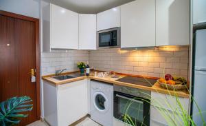 a kitchen with a washing machine and a washer at Luxury Executive Stay - Fuengirola Center in Fuengirola