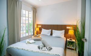 a bedroom with a bed with two shoes on it at Luxury Executive Stay - Fuengirola Center in Fuengirola