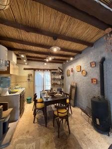 a kitchen and dining room with a table and a stove at Nogal de Luz in La Rioja