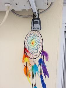 a dream catcher ornament hanging on a wall at Studio Castra in Thessaloniki