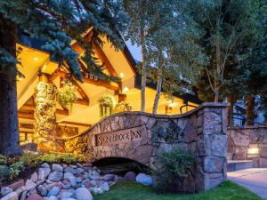a resort with a stone bridge in front of a building at Stonebridge Inn in Snowmass Village