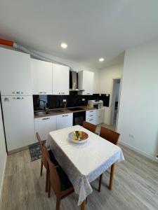 a kitchen with a table with a plate of food on it at House31 in Monfalcone