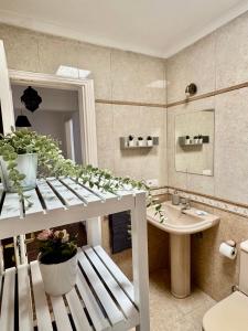 a bathroom with a sink and a toilet and a mirror at Villa Morriña by Vulcano Homes in Playa Honda