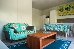 a living room with a couch and a table at Avana Valley Heights in Rarotonga