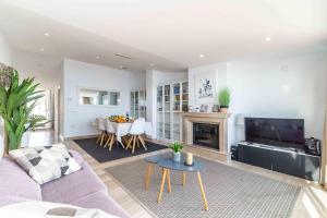 a living room with a couch and a table at Luxury Sea View Penthouse - Fuengirola Beach in Fuengirola