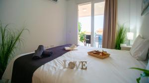 a bedroom with a bed with shoes on it at Executive Sweet Stay - High-End Fuengirola with FREE parking in Fuengirola +6 photos