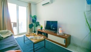 a living room with a tv on a table at Executive Sweet Stay - High-End Fuengirola with FREE parking in Fuengirola