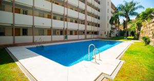 a swimming pool in front of a building at Executive Sweet Stay - High-End Fuengirola with FREE parking in Fuengirola
