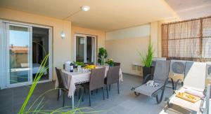 a dining room with a table and chairs on a patio at Executive Sweet Stay - High-End Fuengirola with FREE parking in Fuengirola