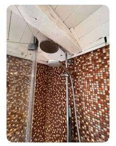 a shower in a bathroom with a tile wall at Downtown Dreams in Madrid +21 photos
