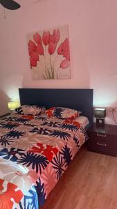a bedroom with a bed and a painting on the wall at Beach Apartment la Arena in Puerto de Santiago