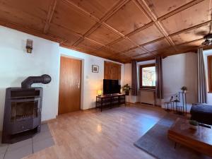 a living room with a couch and a fireplace at Ferienwohnung mit Kamin und Balkon in Samnaun
