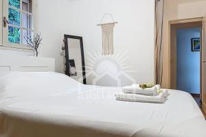 a bedroom with two white towels on a bed at LES OLIVIERS Villa for 6 By Sunset in Grasse
