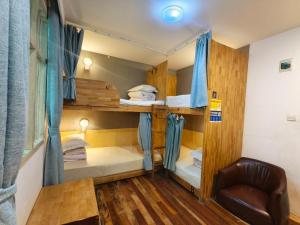 a room with two bunk beds and a chair at Guilin Cyan Box Guest House in Guilin +43 photos