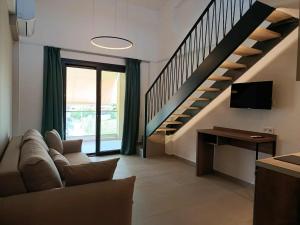 a living room with a couch and a staircase at Sagini Suites in Paradisos
