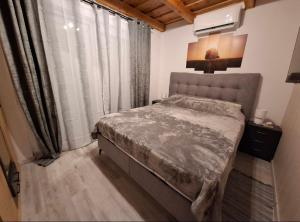 a bedroom with a bed and a large window at Kuća za odmor Vila Valentina in Škriljevec +15 photos