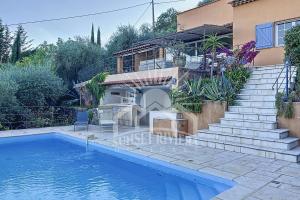 a house with a swimming pool next to a house at LES OLIVIERS Villa for 6 By Sunset in Grasse