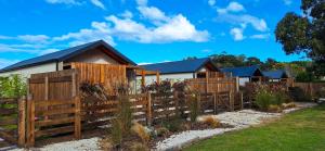 a wooden fence in front of a house at IZ chapa - Casa 3 - Casa en Chapa a estrenar a cuatro cuadras de Luna Roja - Hola Sur in Chapadmalal