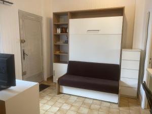a living room with a couch and a tv at Studio 20m2 Ground Floor street in Colombes