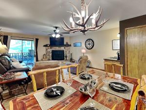 a living room with a dining room table with glasses on it at Innsbrook 254 in Ruidoso +32 photos