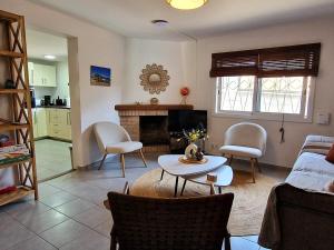 a living room with a table and chairs and a fireplace at Villa de Gracia Casa 4 in Tordera