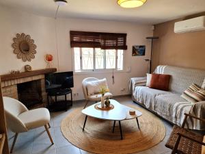 a living room with a couch and a table at Villa de Gracia Casa 4 in Tordera