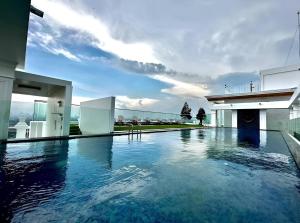 a swimming pool in the middle of a house at The Empire Tower in Jomtien Beach