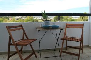 two chairs and a small table on a balcony at Vasilina in Faliraki