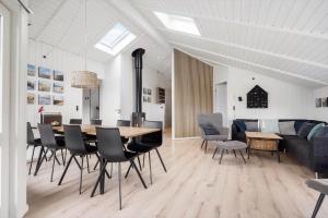 a dining room and living room with a table and chairs at 090-Ringkobing-Klaegdalen-9 in Ringkøbing