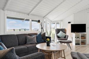 a living room with a couch and a table at 090-Ringkobing-Klaegdalen-9 in Ringkøbing