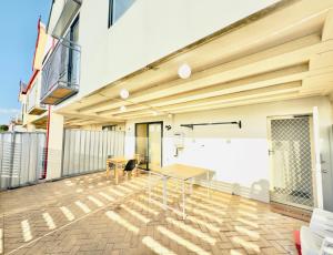 an empty room with a table on a balcony at City Explorer Base 3BR&2 Floors&Walk to Mall & Airport Transit in Perth