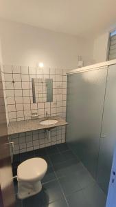 a bathroom with a toilet and a sink at Bravo City Hotel Birigui in Birigui