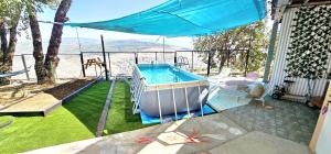 a swimming pool on a patio with a view of the water at הנץ in Gilon