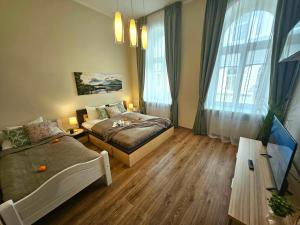 a bedroom with a bed and a couch in it at Avocado Old Town 2BR Spacious Apartment near Dome Square in Rīga
