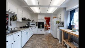a large white kitchen with white cabinets and appliances at New - Inn the Mountains - near Tonto Nat'l Forest in Payson
