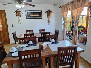 a dining room with a wooden table and chairs at Hostal Casa Amarilla San Vicente de Tagua Tagua in San Vicente de Taguatagua