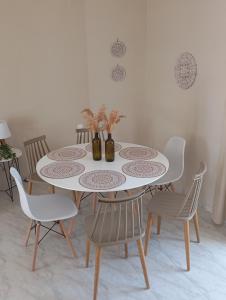 a dining room table with chairs and a white table at Thea Rooftop in Skiathos +24 photos