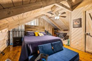 a bedroom with a bed and a ceiling fan at Unique Charm, Central Location, Hot Tub, Games in Sevierville