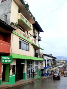 a man walking down a street in front of a building at Hotel EL EDEN 2 personas 9 in Cedro