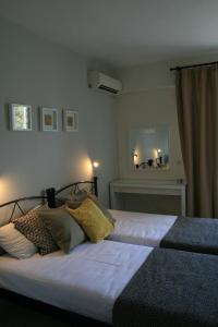 a bedroom with two beds with white sheets at Vasilina in Faliraki