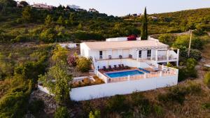 an aerial view of a white house with a swimming pool at Carpe Diem in Faro