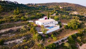 an aerial view of a white house on a hill at Carpe Diem in Faro