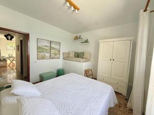a bedroom with a white bed in a room at Casa Ale, Stunning Sea Views in Las Aguas +34 photos