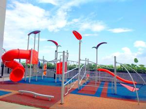 a playground with a red slide and slides at ABHome "FRIDAY Suite" #Midas Seri Alam #City view #Mall #Masai JB in Masai