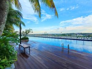 a wooden deck with a bench and a view of the water at ABHome "FRIDAY Suite" #Midas Seri Alam #City view #Mall #Masai JB in Masai