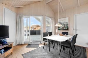 a dining room with a white table and black chairs at 150-Ringkobing-Krogen-8 in Ringkøbing +21 photos
